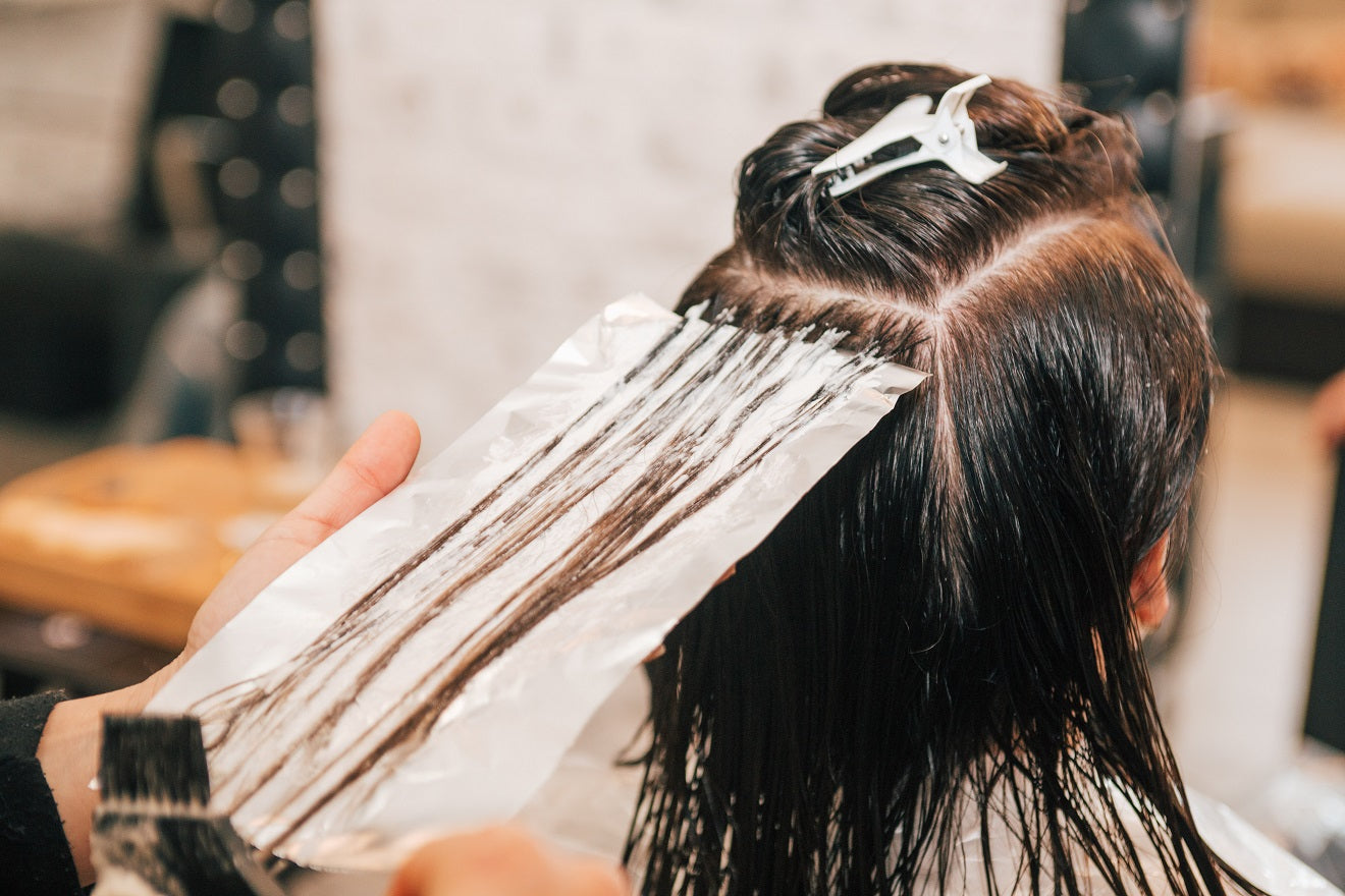 Woman getting hair colored at salon