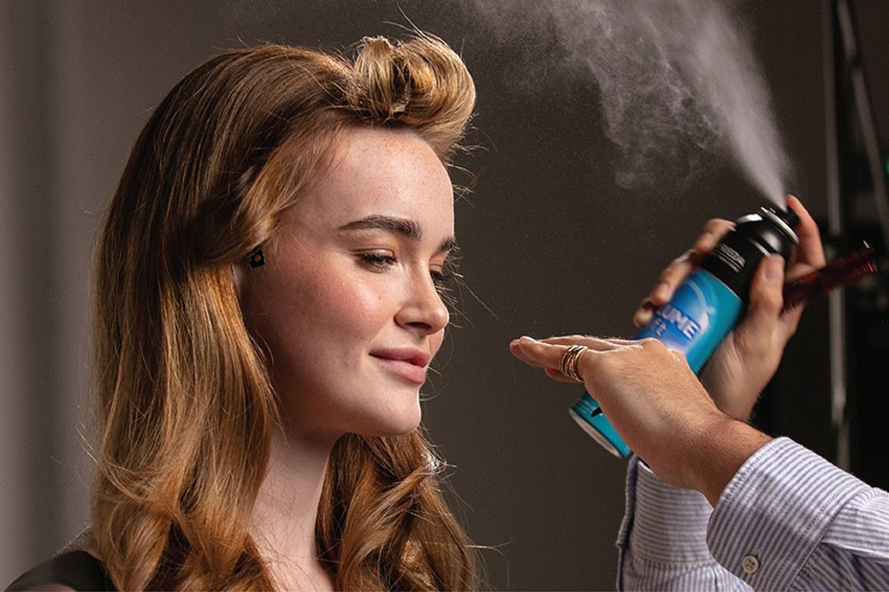 Woman spraying volume lift into her hair